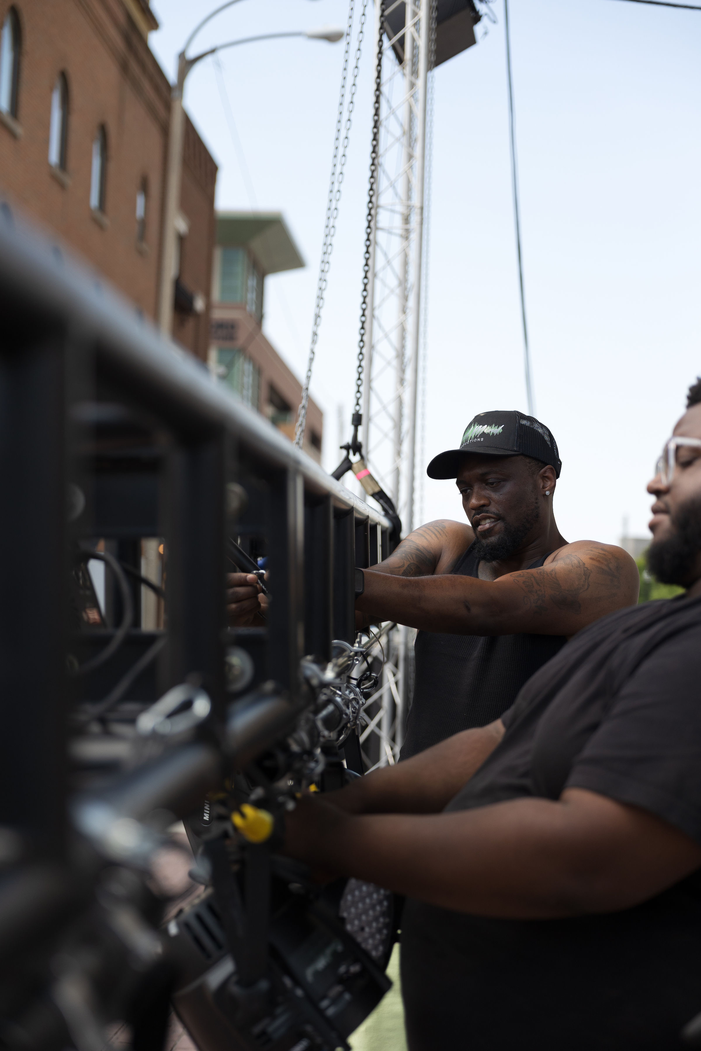 Crew member adjusting rigging on the truss